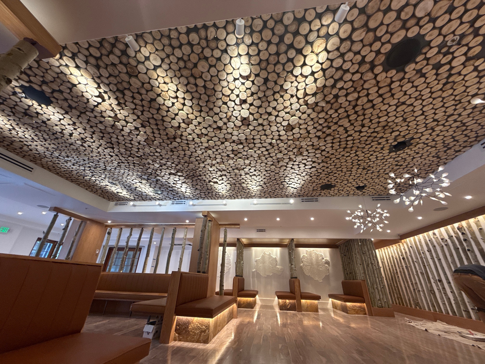 well lit aspen vertical aspen poles and "cookie" cut aspen installed on ceiling